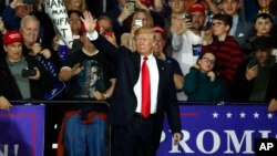 U.S. President Donald Trump waves after a campaign rally in Washington Township, Michigan, April 28, 2018.
