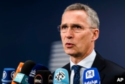 NATO Secretary-General Jens Stoltenberg talks with journalists as he arrives for a meeting of EU foreign and defense ministers at the Europa building in Brussels, May 18, 2017.