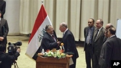 Iraq's President Jalal Talabani, center left, shakes hands with Osama al-Nujeifi, center right, the elected parliament speaker during a Parliament session in Baghdad, Iraq, 11 Nov 2010