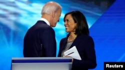FILE - Former Vice President Joe Biden talks with Senator Kamala Harris after the conclusion of the 2020 Democratic U.S. presidential debate in Houston, Texas, U.S., September 12, 2019. (REUTERS/Mike Blake/File Photo)