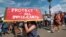 FILE - Supporters of Deferred Action for Childhood Arrivals chant slogans and carry signs in Los Angeles, Sept. 4, 2017.