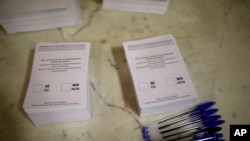 Ballots ready to be used by voters sit on a table at a sports center assigned to be a polling station by the Catalan government and where Catalan President Carles Puigdemont is expected to vote, in Sant Julia de Ramis, near Girona, Spain, Oct. 1, 2017.