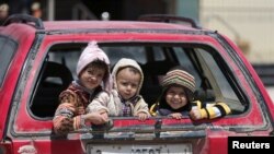 Children sit in a car in Benghazi, Libya. UNICEF says nearly 200,000 children in Libya need clean water, and more than 300,000 need educational support.