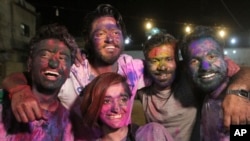Youth from the Pakistani Hindu community pose with their faces covered with color to celebrate Holi, the festival of colors, at a temple in Karachi, Pakistan, March 12, 2017.