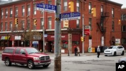 In this Oct. 25, 2017, photo, pedestrians and motorists pass along State Street, the main thoroughfare through town in Erie, Pa. In the 12 months since Donald Trump’s election, Erie has shed over 800 jobs. The number of people seeking jobs declined by more than 2,000. (AP Photo/John Minchillo)