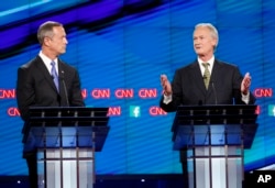 Democratic presidential candidates former Maryland Gov. Martin O'Malley, left, listens as former Rhode Island Gov. Lincoln Chafee speaks during the CNN Democratic presidential debate Tuesday, Oct. 13, 2015.