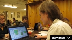 Abigail Larkin reviews a map database of information from Adirondack hiking trail registers at the State University of New York College of Environmental Science and Forestry research station in Newcomb, New York, on Wednesday, June 12, 2013. 