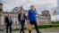 Chancellor Angela Merkel walks to the Chancellery, accompanied by her bodyguards, after the government questioning in the Bundestag in Berlin, Germany, May 13, 2020.