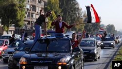 Les partisans du gouvernement syrien manifestent contre les frappes occidentales à Damas, Syrie, 14 avril 2018.