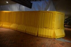 2021年12月22日夜间，港大校园内原先放置国殇之柱的位置以塑料板围封。（（Galileo Cheng/HK Frontline Media ）