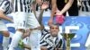 Juventus' Carlos Tevez, of Argentina, celebrates next to the Serie A trophy following the match between Juventus and Cagliari, Turin, Italy, May 18, 2014.