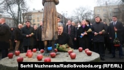 In central Kyiv on Nov. 25, 2017, President Petro Poroshenko and hundreds of other people lay symbolic wheat ears and light candles before the monument commemorating victims of the famine.