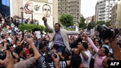 FILE - Khaled Elbalshy demonstrates with fellow journalists outside the Journalists Syndicate headquarters in Cairo, May 4, 2016, following the arrests of two reporters.