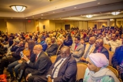 Members of the Sudanese diaspora listen to Sudan's Prime Minister Abdalla Hamdok as he addresses them at a Washington hotel. (Twitter - @SudanPMHamdok)