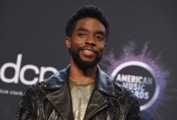 FILE - Chadwick Boseman poses in the press room at the American Music Awards on Nov. 24, 2019, at the Microsoft Theater in Los Angeles.