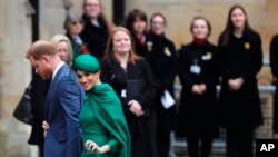 Britain's Prince Harry and Meghan, Duchess of Sussex, arrive to attend the annual Commonwealth Day service at Westminster Abbey in London.