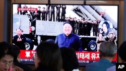 People watch a TV showing a file image of North Korean leader Kim Jong Un during a news program at the Seoul Railway Station in Seoul, South Korea, Oct. 2, 2019.