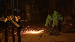 Nelson Muzhuwe, who manufactures door and window frames, says he is recovering from a cold he caught while working overnight in Harare, July 9, 2019. (Columbus Mavhunga/VOA)