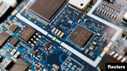 FILE - Semiconductor chips are shown on a circuit board. An updated rule curbing exports of U.S. chipmaking equipment to China is in the final stages of review, a U.S. government agency posting said on Oct. 5, 2023.