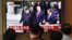 FILE - People watch a television news screen showing U.S. President Donald Trump, South Korean Moon Jae-in and North Korean leader Kim Jong Un meeting at the truce village of Panmunjom in the DMZ, at a railway station in Seoul, June 30, 2019. 