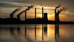 FILE - The coal-fired Plant Scherer, one of the nation's top carbon dioxide emitters, stands in the distance in Juliette, Ga., June 3, 2017. The Trump administration intends to roll back the centerpiece of former President Barack Obama’s efforts to slow g