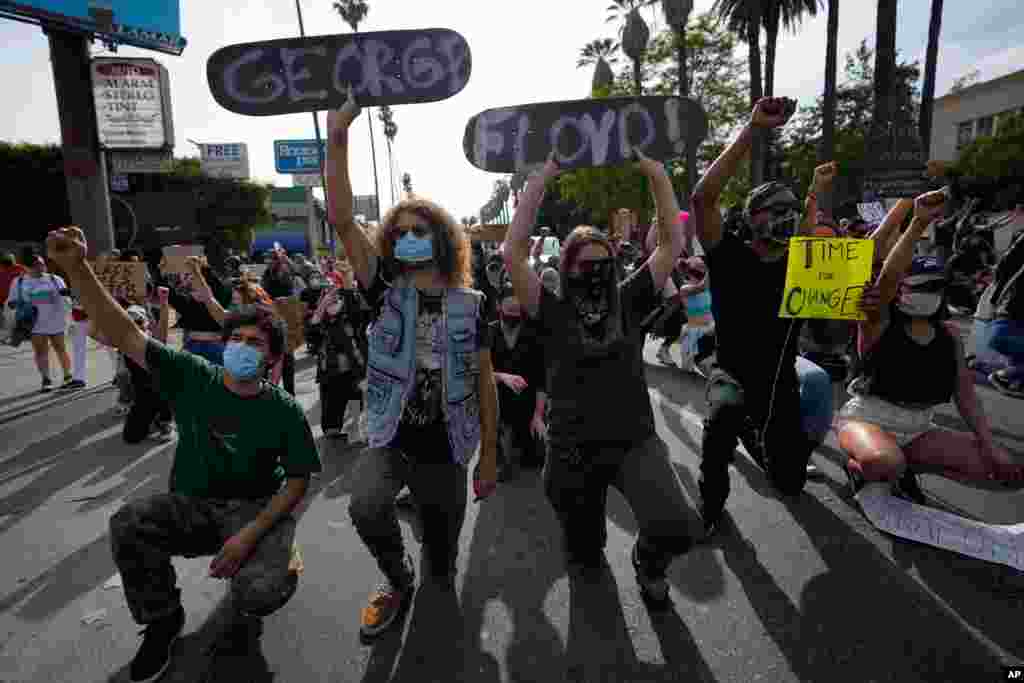 Demonstrators kneel in the Hollywood area of Los Angeles, June 1, 2020, during a protest over the death of George Floyd.