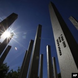 Sunshine reflects from the pillars of the memorial to the victims of the July 7, 2005 London bombings, in Hyde Park, central London May 2, 2011