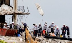 Emergency workers conduct search and rescue efforts at the site of a partially collapsed residential building in Surfside, near Miami Beach, Florida, U.S., June 30, 2021.