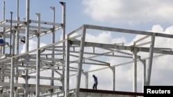 FILE - A man works at a construction site of a foreign invested project in Vietnam's southern financial hub Ho Chi Minh city, Aug. 27, 2015. Vietnam's top leaders are looking to attract more foreign investment in manufacturing. (Reuters)