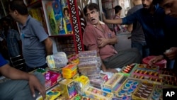 An Indian shopkeeper sells firecrackers in New Delhi, Oct. 9, 2017. 