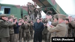 North Korean leader Kim Jong Un, center, guides the test fire of a new multiple launch rocket system in this undated photo released by North Korea's Korean Central News Agency (KCNA) in Pyongyang, March 4, 2016. 