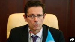 FILE - U.N. Assistant Secretary-General for Human Rights Ivan Simonovic speaks during his meeting with First Deputy Prime Minister of Crimea government Rustam Temirgaliev in Simferopol, Friday, March 21, 2014.