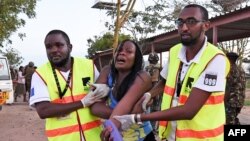 FILE - Paramedics help a student who was injured during an attack by Somalia's al-Qaida-linked al-Shabab gunmen at Garissa University College, Kenya, April 2, 2015. 
