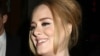 British singer Adele greets her fans after her concert at Radio City Music Hall on Nov. 17, 2015 in New York.