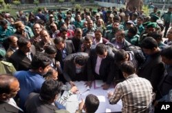 Bangladeshi elections officials gather to collect voting material at a distribution center on the eve of the general elections in Dhaka, Bangladesh, Saturday, Dec. 29, 2018.