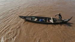 A Cambodian Muslim man rows his wooden boat where he lives along the Mekong River bank at a fisherman floating village located in Kball Chroy, near Phnom Penh, Cambodia, on Monday, Sept. 9, 2019. (AP Photo/Heng Sinith)