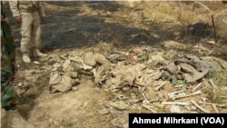 A mass grave in Sinjar, Iraq, believed to contain the remains of Yazidi members massacred by IS two years ago, is seen after a fire broke out in early June, 2016.