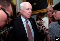 FILE - Sen. John McCain, R-Ariz., speaks with reporters before heading into a policy luncheon on Capitol Hill, Sept. 19, 2017, in Washington.