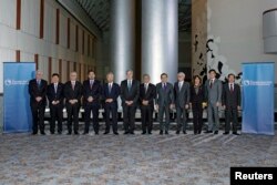 FILE - Trade ministers from a dozen Pacific nations in Trans-Pacific Partnership Ministers post-meeting in TPP Ministers "Family Photo" in Atlanta, Georgia, Oct. 1, 2015.