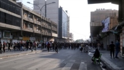 Supporters of Iraqi Shiite armed groups run from security forces after clashes during a protest against the election results in Baghdad, Iraq, Nov. 5, 2021
