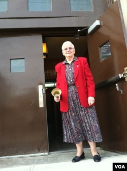 Sister Agnes welcomes students back to Saint Camillus Catholic school. The building reopened this week after being damaged by Superstorm Sandy. (VOA/A. Phillips)