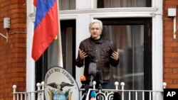 FILE - WikiLeaks founder Julian Assange gestures as he speaks on the balcony of the Ecuadorian embassy, in London, May 19, 2017. 