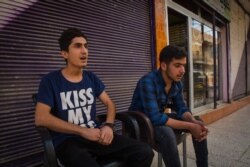 The families of Omet, 18, and Wasee, also 18, are among the few remaining after three days of evacuations. "When you go outside at night, it feels like you are the only one in the city," in Darbasiyah, Syria, Oct. 22, 2019. (VOA/Yan Boechat)