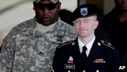 Army Pfc. Bradley Manning, right, is escorted out of a courthouse in Fort Meade, Maryland, June 25, 2012. 