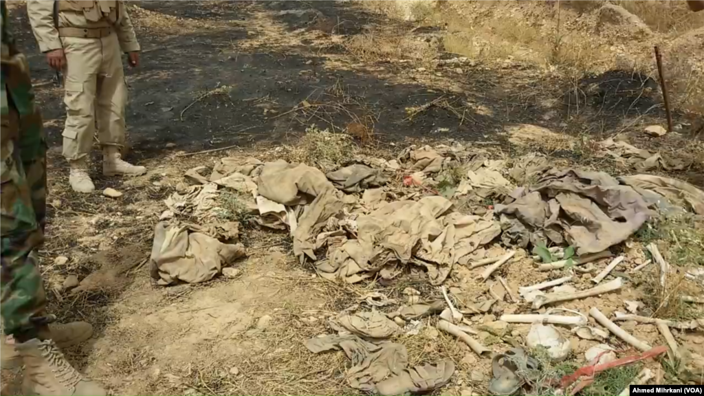 A mass grave in Sinjar, Iraq, believed to contain the remains of Yazidi members massacred by IS two years ago, is seen after a fire broke out in early June, 2016.