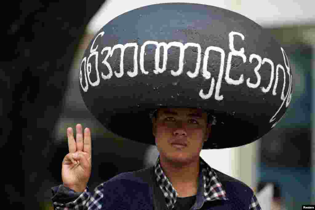 A demonstrator flashes the three-finger salute during a protest against the military coup in Yangon, Myanmar, Feb. 22, 2021.