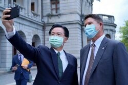 Taiwan's Foreign Minister Joseph Wu, left, takes a selfie with Keith Krach, U.S. undersecretary of state for economic growth, energy and the environment, in Taipei, in this photo provided by Taiwan’s Ministry of Foreign Affairs, Sept. 18, 2020.