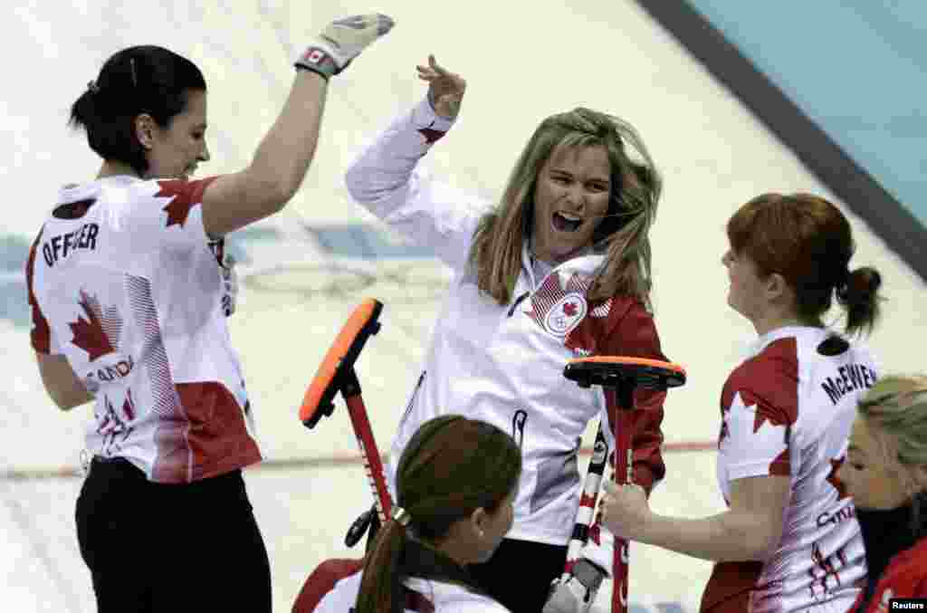 Canada&#39;s skip Jennifer Jones (center) celebrates with teammates Jill Officer (left) and lead Dawn McEwen after winning the women&#39;s curling semifinal game against Britain, Ice Cube Curling Center, Sochi Feb. 19, 2014.