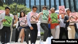 한국 상인들이 지난 7일 서울에서 일본 상표가 그려진 상자를 밟으며 일본 제품 불매를 선언하고 있다.