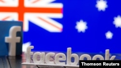 FILE - A 3D-printed Facebook logo is seen in this illustration photo atop a keyboard with an Australian flag in the background.
